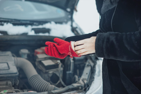 girl takes off his gloves to repair the car