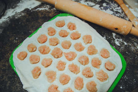 raw dumplings on the kitchen table with flourの写真素材