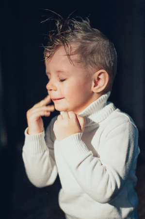 emotional child having fun on a dark backgroundの写真素材