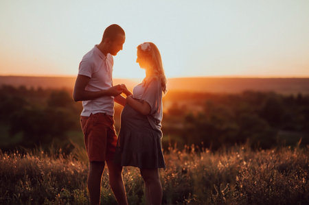couple in love against the backdrop of a beautiful sunset. Pregnancy