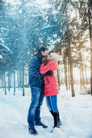 Man with a woman walking in the winter snow parkの写真素材