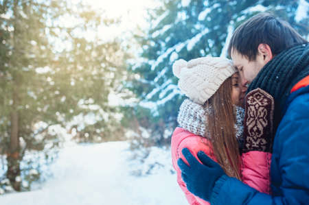 Man with a woman walking in the winter snow parkの写真素材