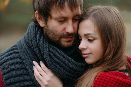 Stylish man and woman in a scarf on natureの写真素材