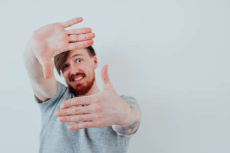 man with  beard looks through his handsの写真素材