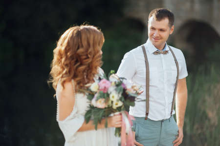 The bride and groom in nature. Rustic Weddingの写真素材