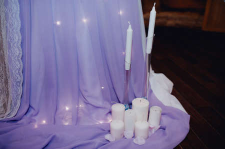 White candles near the table. Wedding decorationsの写真素材