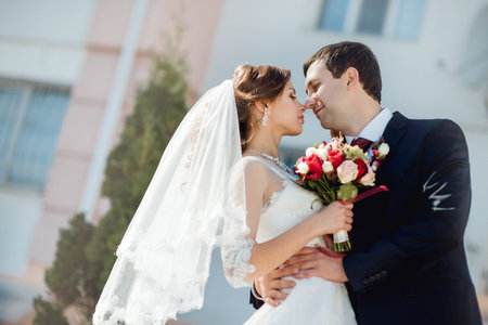 the bride and groom on the background of urban architecture