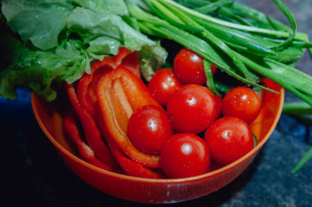 fresh tomatoes, pepper, onions and salad in a bowlの写真素材