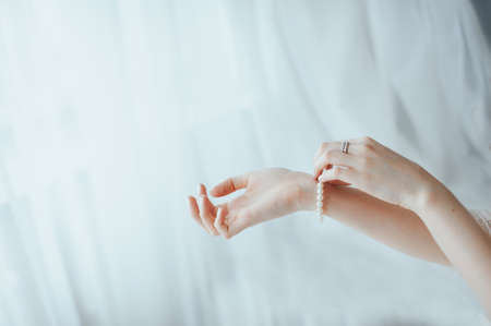 The bride wears a bracelet on handの写真素材