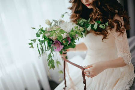 Bride with a beautiful bouquet of different colors. Close-upの写真素材