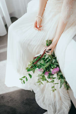 Bride with a beautiful bouquet of different colors. Close-upの写真素材