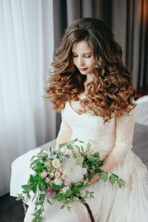 Luxury stylish bride sitting on the bedの写真素材