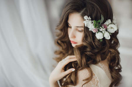 Luxury stylish bride sitting on the bed and looking at the cameraの写真素材