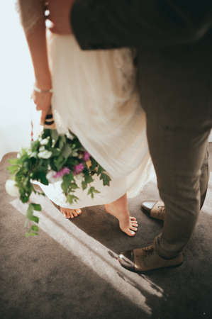 The bride and groom on the window backgroundの写真素材