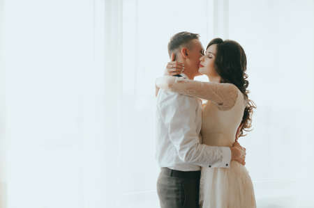 The bride and groom on the window backgroundの写真素材