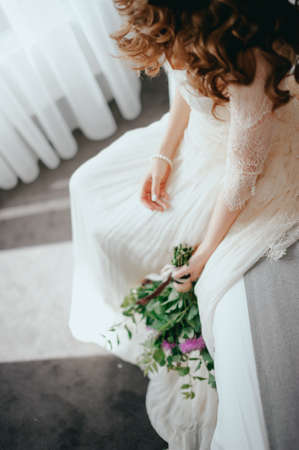 Bride with a beautiful bouquet of different colors. Close-upの写真素材