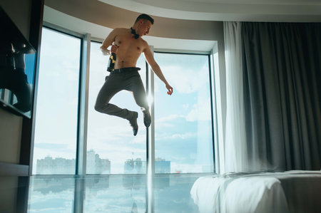 Man bare-chested jumping on the window background