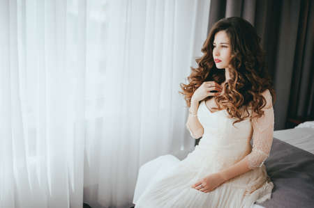 Luxury stylish bride sitting on the bedの写真素材