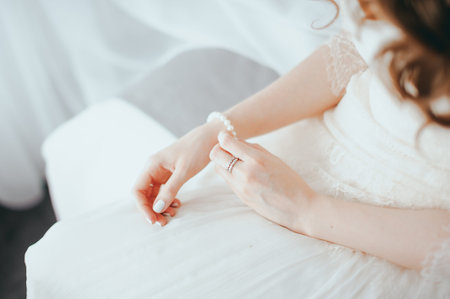 the bride wears a bracelet on handの写真素材