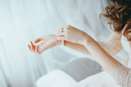 the bride wears a bracelet on handの写真素材