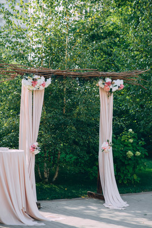 Beautiful wedding ceremony outdoors. Arch made of natural flowers. Decorの写真素材