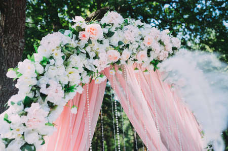 Beautiful wedding ceremony outdoors. Arch made of natural flowers. Decorの写真素材