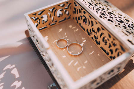 beautiful gold wedding rings on the brides preparationsの写真素材