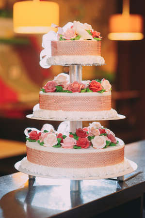 beautiful wedding cake with decorations and flowersの写真素材
