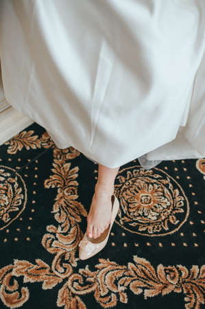 beautiful bride in white dress posing on preparationsの写真素材