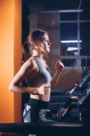 The girl on the treadmill in the gymの写真素材