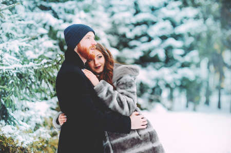 couple in love in the winter forest ,have fun in the forest in winterの写真素材