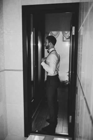 Groom preparing for the wedding. Future husband is waiting for his future wife. black and white photoの写真素材