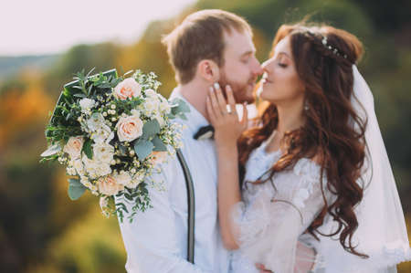 Stylish bride and groom posing on the background of the river. Wedding coupleの写真素材