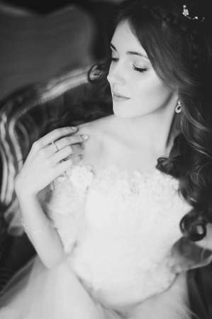 beautiful bride posing in hotel. wedding in the style of fine artの写真素材