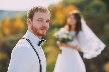Bride and groom walking in nature. A stylish wedding. Love story. Rustic style.の写真素材