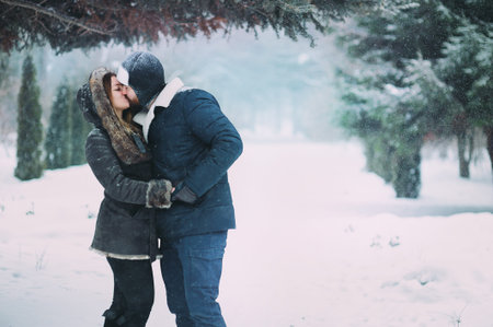 loving couple having fun in the snowy forest