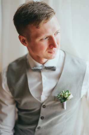 Handsome groom at wedding tuxedo waiting for bride. Rich groom at wedding dayの写真素材