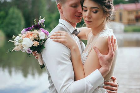 stylish bride and groom at the lake at the weddingの写真素材