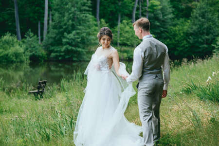 bride and groom posing for a walk in the woodsの写真素材