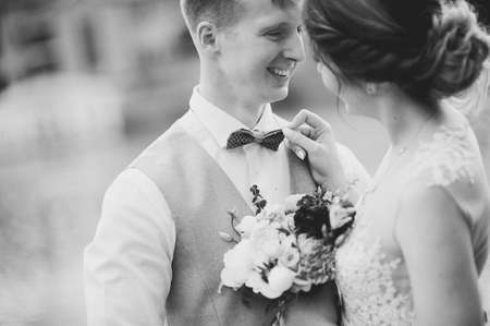 Elegant gentle stylish groom and bride near river or lake. Wedding couple in loveの写真素材