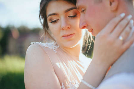 Fine art photo of an attractive wedding couple. posing at sunsetの写真素材