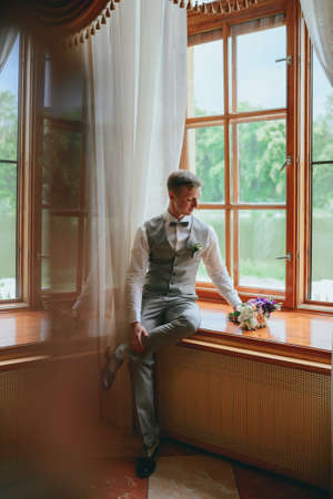 Handsome groom at wedding tuxedo waiting for bride. Rich groom at wedding dayの写真素材
