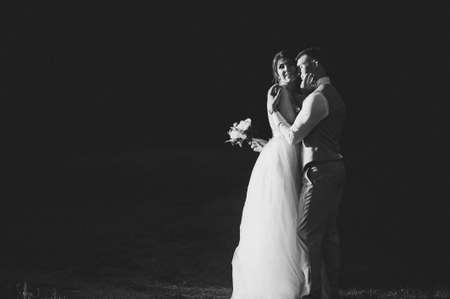 the bride and groom at sunset on a dark backgroundの写真素材