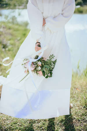 Beautiful bride on the river Bank. Beautiful bride posing.の写真素材