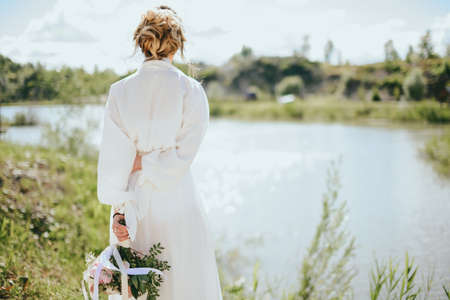 Beautiful bride on the river Bank. Beautiful bride posing.の写真素材