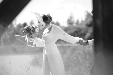 Happy couple in love having fun outdoors with party set mask.