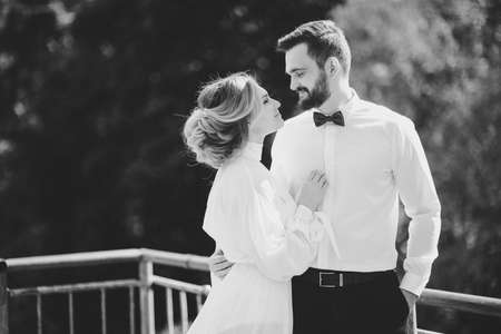 the bride and groom posing on a suspension bridgeの写真素材