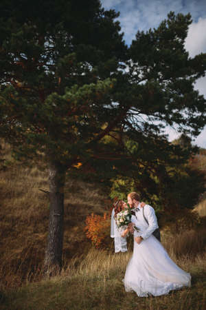 stylish bride and groom posing at the tree. fine art style. rustic. boho.の写真素材