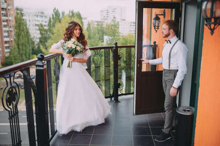 A stylish elegant bride and groom posing near the hotelの写真素材