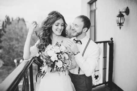A stylish elegant bride and groom posing near the hotelの写真素材